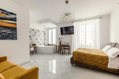 a bedroom with a bed and a tub and a table at BeB Domus Arbenzio San Giovanni Suite in Rome