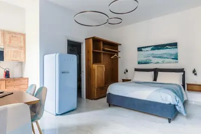 a bedroom with a bed and a blue refrigerator at BeB Domus Arbenzio San Giovanni Suite in Rome