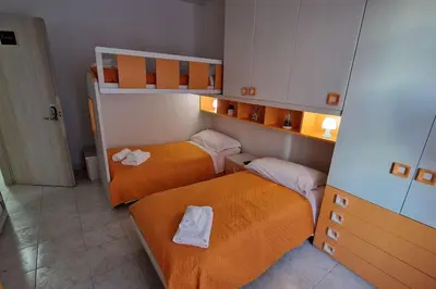 a small room with two bunk beds in it at Brik's House in Rome