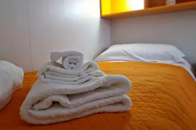 a pile of towels sitting on top of a bed at Brik's House in Rome