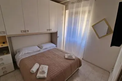 a small bedroom with a bed with towels on it at Brik's House in Rome