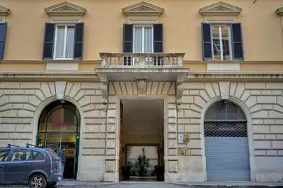 a building with a balcony and a car parked in front at Volturno's Unique View in Rome