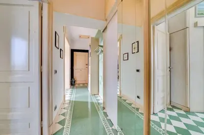 a hallway with a green and white checkered floor at Volturno's Unique View in Rome