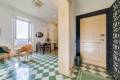 a room with a door and a checkered floor at Volturno's Unique View in Rome