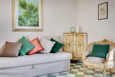 a living room with a couch and a chair at Volturno's Unique View in Rome