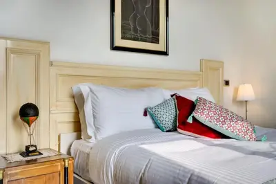 a bedroom with a bed with pillows on it at Volturno's Unique View in Rome