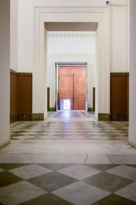 an empty hallway with a wooden door in a building at Volturno's Unique View in Rome