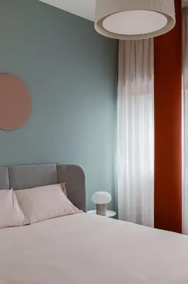 a bedroom with a white bed and a white curtain at 4BNB - Suites del Gallo in Rome