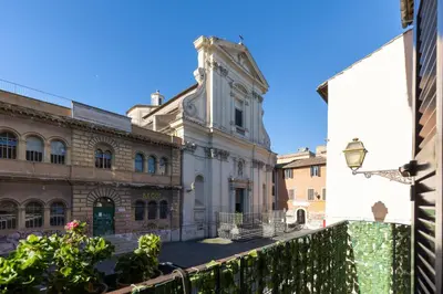an old building with a clock tower in a city at Rome As You Feel - Designer two-level apartment in the heart of Trastevere in Rome