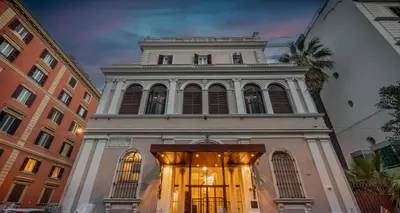 a tall white building with a clock tower at BH Hotel in Rome