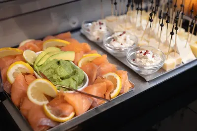 a bunch of different types of food on trays at BH Hotel in Rome