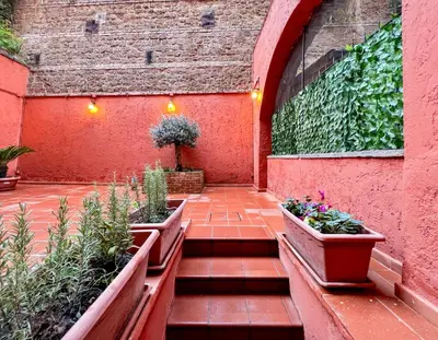 a courtyard with two planters with plants in it at LA CORTE at the Colosseum in Rome