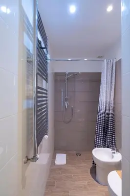 a bathroom with a shower and a toilet and a sink at Sognando Vacanze Romane in Rome