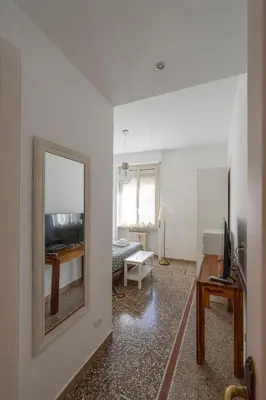 a living room with a mirror and a table at Sognando Vacanze Romane in Rome