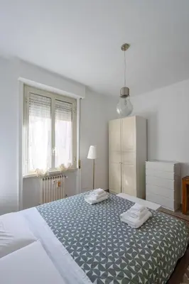 a bedroom with a large bed with two pillows on it at Sognando Vacanze Romane in Rome