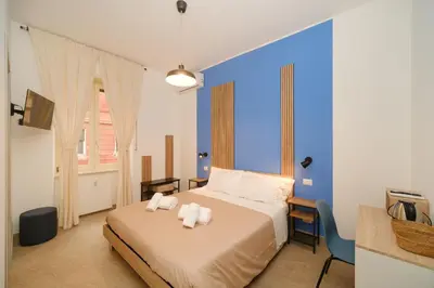 a bedroom with a bed with two towels on it at Domus Equi in Rome