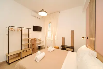 a bedroom with a bed with two white pillows at Domus Equi in Rome