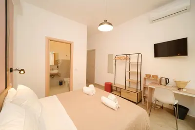 a bedroom with a bed with two pillows on it at Domus Equi in Rome