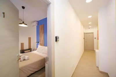 a bedroom with a bed and a hallway at Domus Equi in Rome