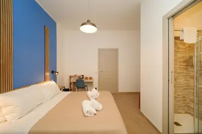 a bedroom with a bed with white towels on it at Domus Equi in Rome