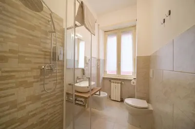 a bathroom with a shower and a toilet and a sink at Domus Equi in Rome