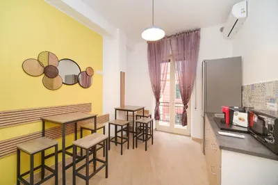 a restaurant with tables and stools in a room at Domus Equi in Rome