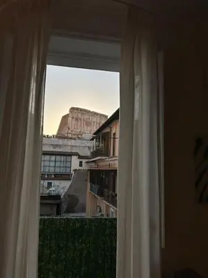 a window in a room with a view of a building at Your nest at Colosseum!! in Rome
