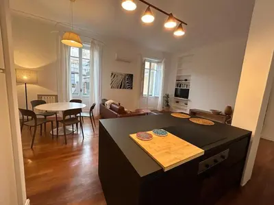 a kitchen and living room with a table and a dining room at Your nest at Colosseum!! in Rome