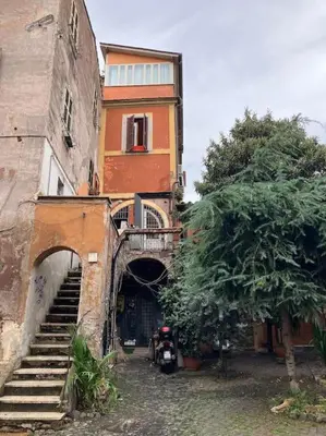 an old building with a staircase leading up to it at Amazing Terrace in Trastevere in Rome