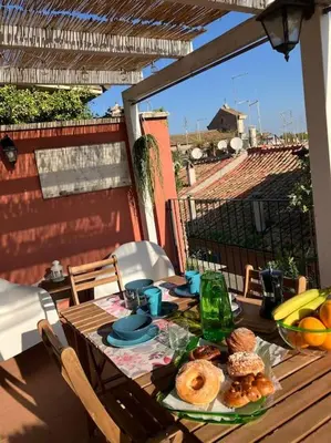 a table with food on it on a patio at Amazing Terrace in Trastevere in Rome