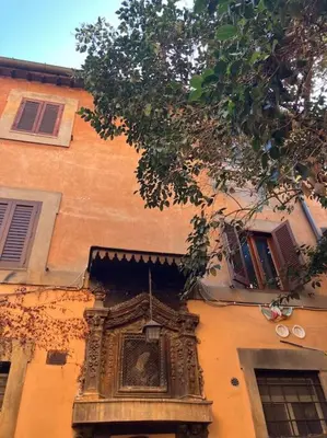 a building with a statue on the side of it at Amazing Terrace in Trastevere in Rome
