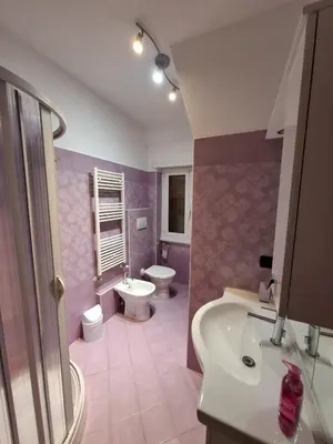 a bedroom with a bed and a window and a desk at APPARTAMENTO ROMAntica House in Rome