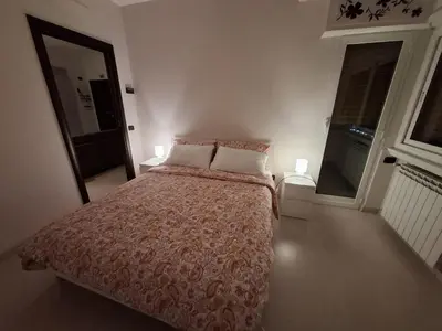 a bedroom with a bed and two lamps and a window at APPARTAMENTO ROMAntica House in Rome
