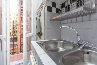 a stainless steel sink in a kitchen with a window at Cami Vatican Apartment in Rome