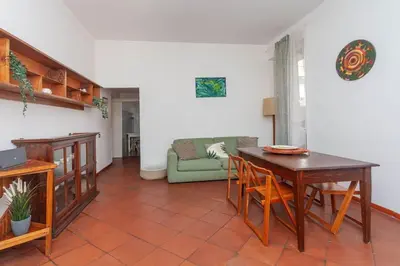 a living room with a table and a couch at Cami Vatican Apartment in Rome