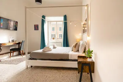 a bedroom with a bed with a large mirror at Central Rooms - Vatican in Rome