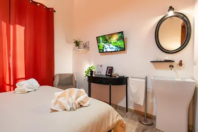 a room with a bed and a mirror and a sink at Central Rooms - Vatican in Rome