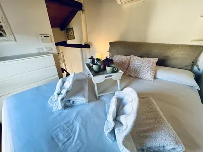 a bedroom with a bed with towels on it at Pantheon Gabbianina Home in Rome