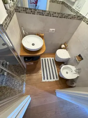 a bathroom with two toilets and a sink at Pantheon Gabbianina Home in Rome