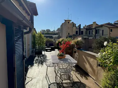 a patio with chairs and a table on a balcony at Pantheon Gabbianina Home in Rome