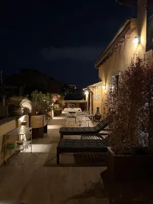 a patio with benches and tables at night at Pantheon Gabbianina Home in Rome