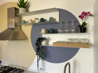a kitchen with a shelf with glasses and plants at Momenti di felicità a Roma in Rome
