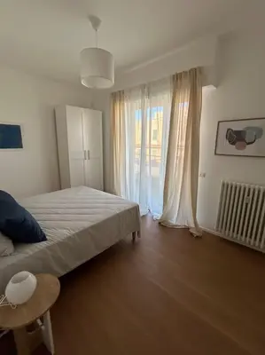 a bedroom with a large bed and a window at Momenti di felicità a Roma in Rome