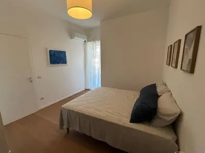 a bedroom with a bed in a white room at Momenti di felicità a Roma in Rome