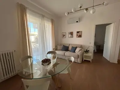 a living room with a glass table and a couch at Momenti di felicità a Roma in Rome