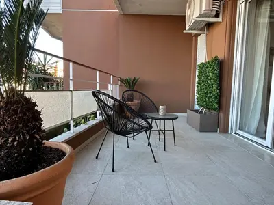 a patio with two chairs and a table on a balcony at Momenti di felicità a Roma in Rome
