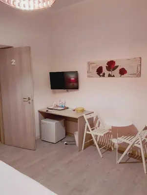 a room with a desk and a computer on a wall at San Giovanni Rooms Roma in Rome