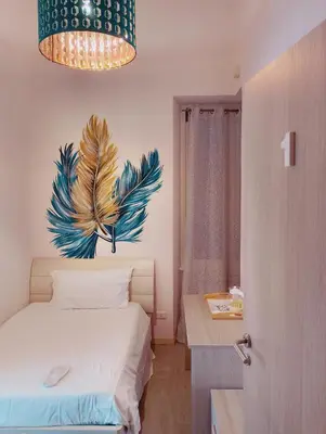 a bedroom with a bed with a painting on the wall at San Giovanni Rooms Roma in Rome