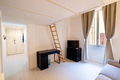 a room with a ladder and a desk and a television at Rome City Center loft - special offer in Rome