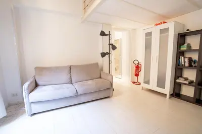 a living room with a couch and a fire extinguisher at Rome City Center loft - special offer in Rome